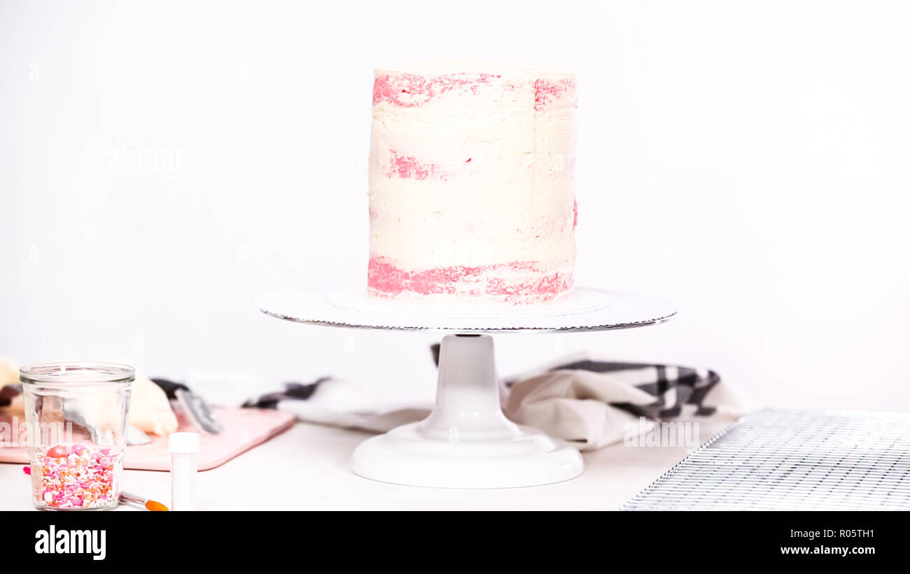 Step by step. Icing tall birthday cake with white buttercream icing