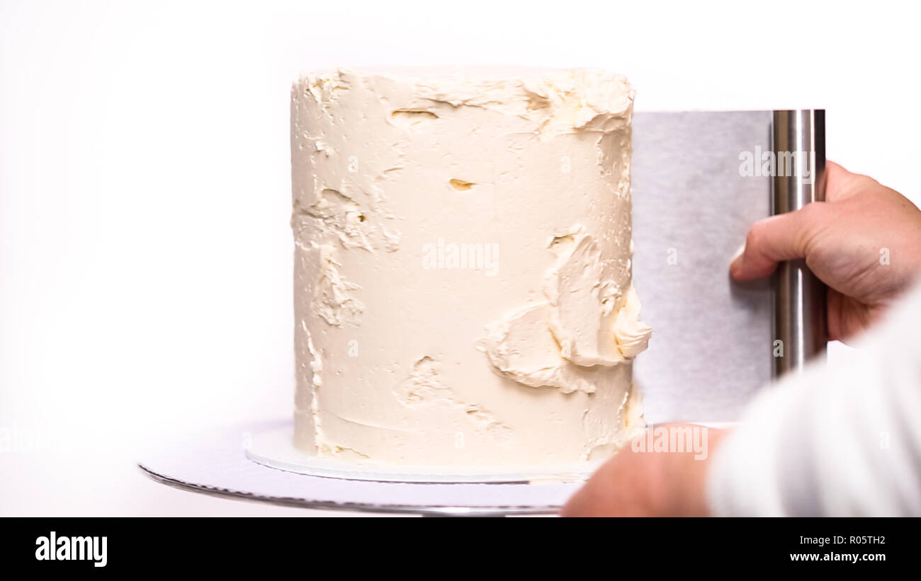 Step by step. Icing tall birthday cake with white buttercream icing