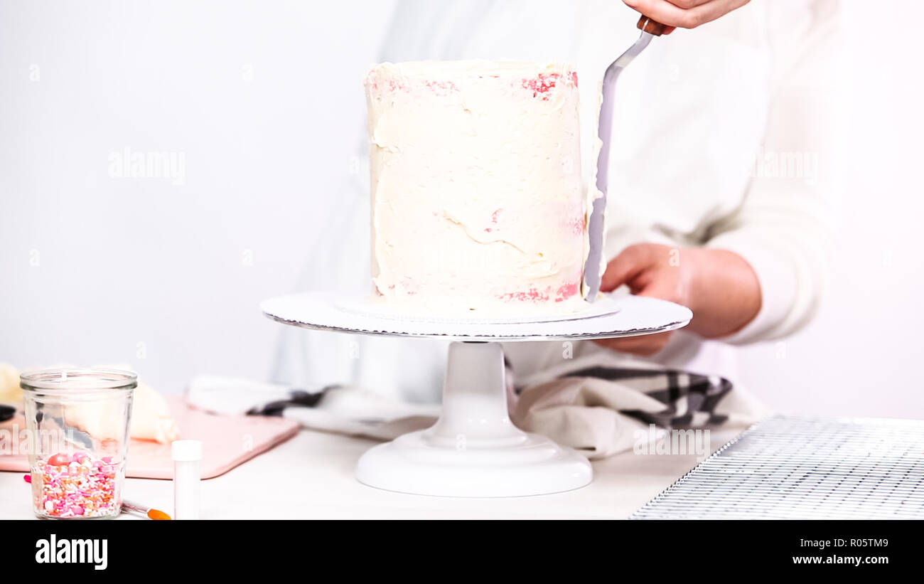Step by step. Icing tall birthday cake with white buttercream icing