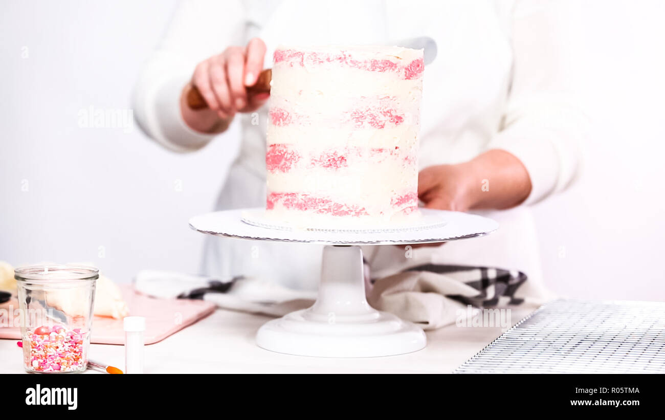 Step by step. Icing tall birthday cake with white buttercream icing
