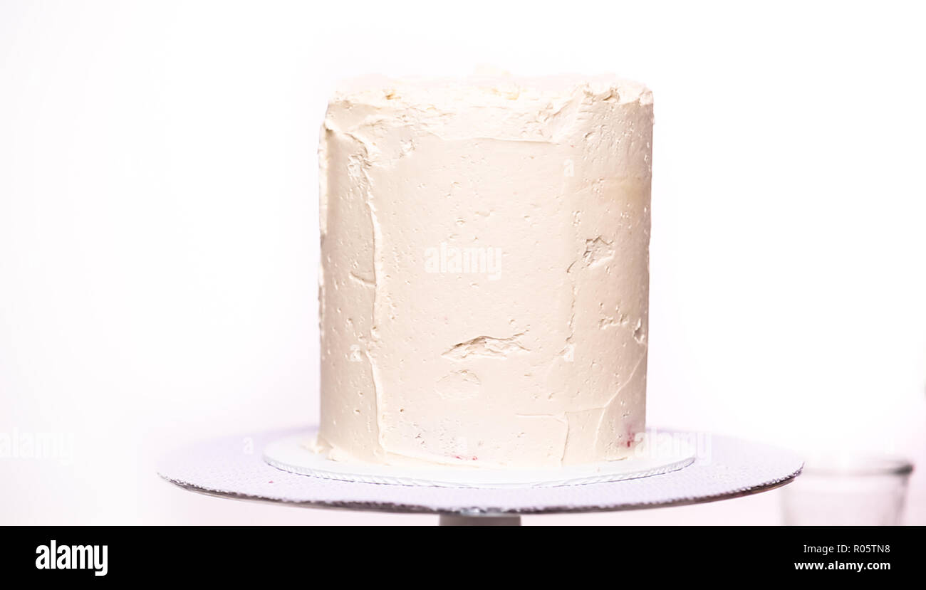 Step by step. Icing tall birthday cake with white buttercream icing