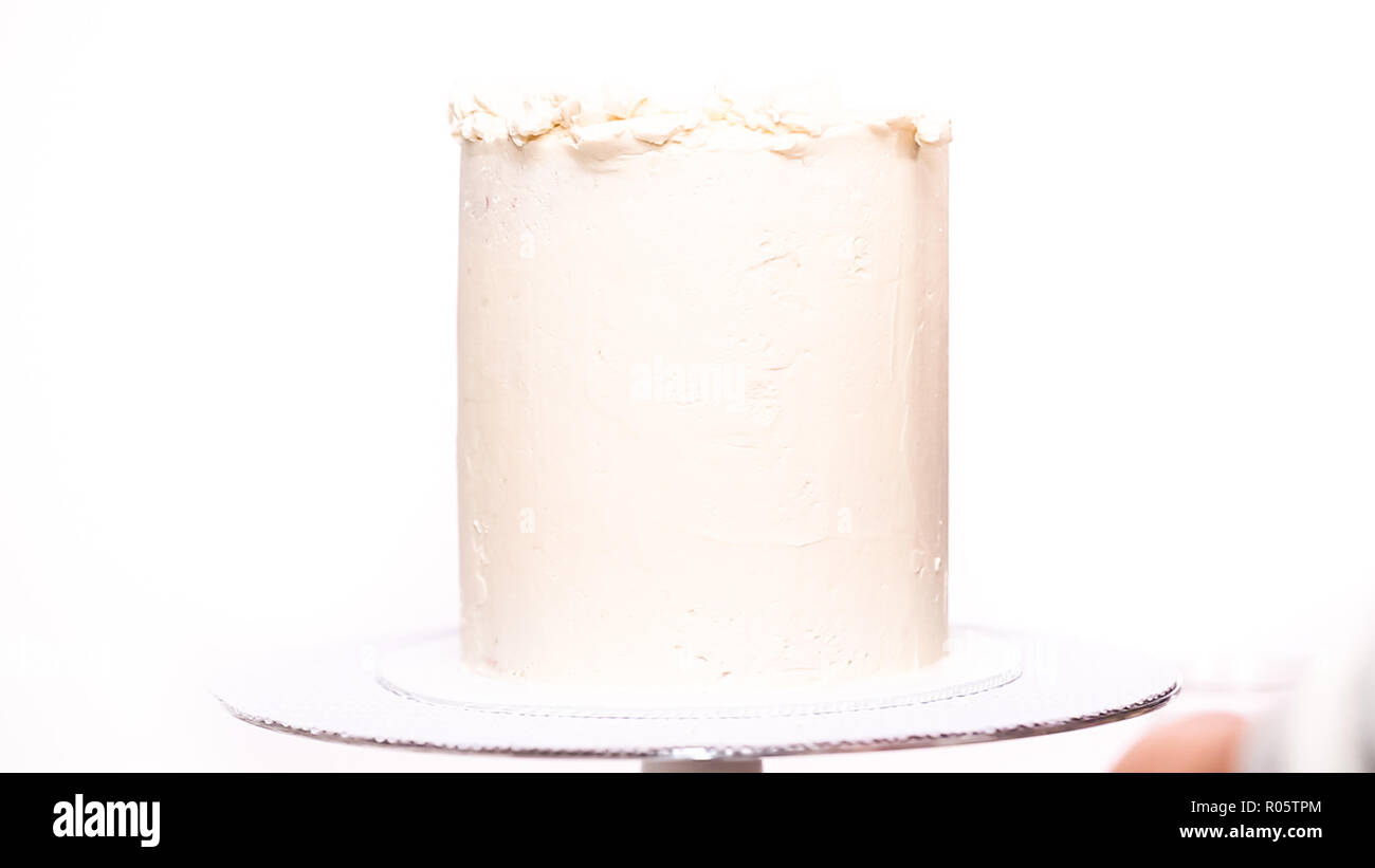 Step by step. Icing tall birthday cake with white buttercream icing