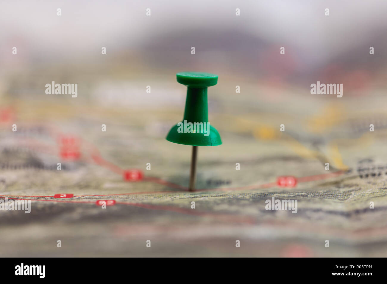 Macro Of Green Pin Marks A Location Of A Destination On A Map