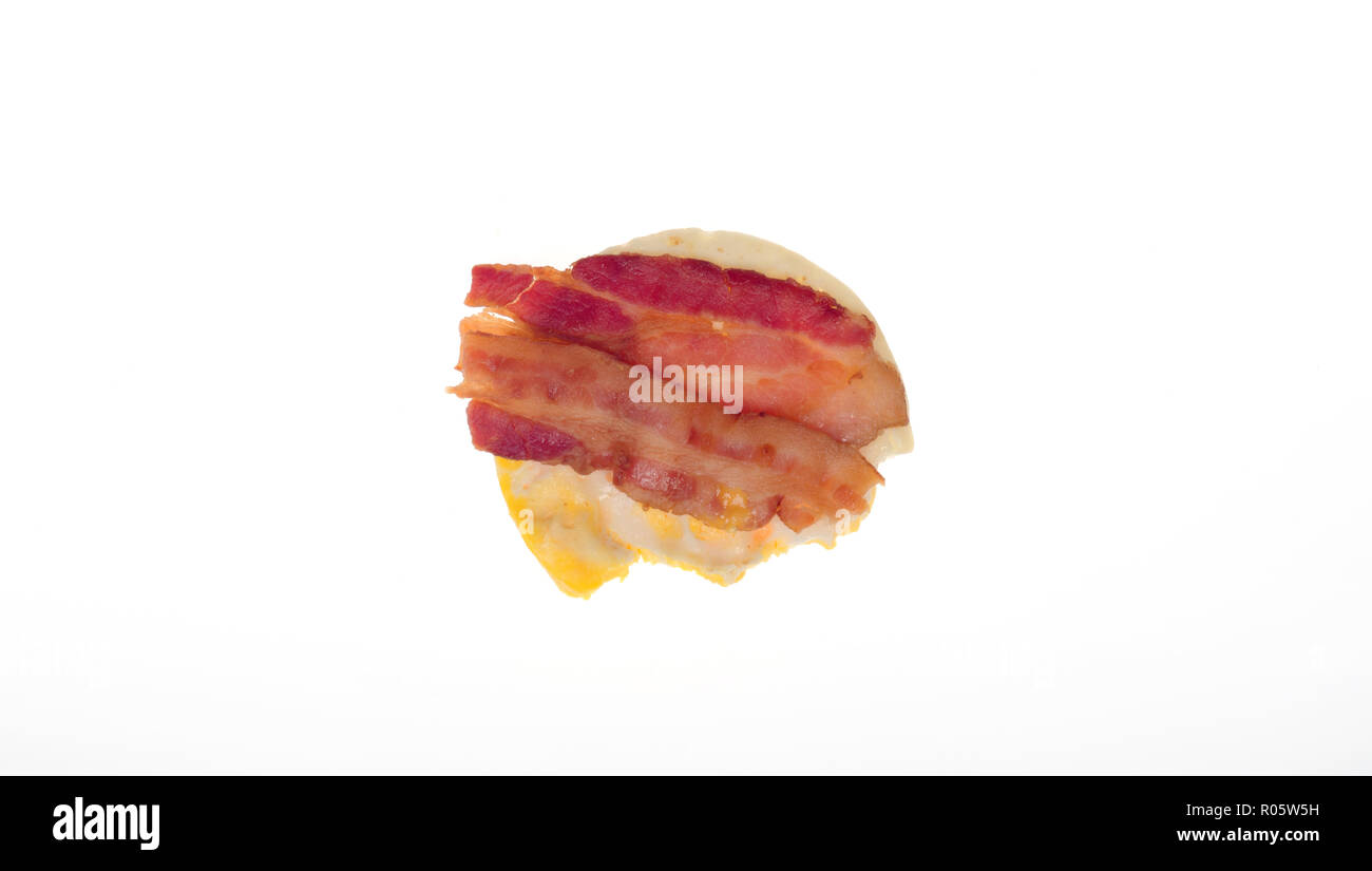 Low carb bacon and egg breakfast with bite taken out from above on white background Stock Photo