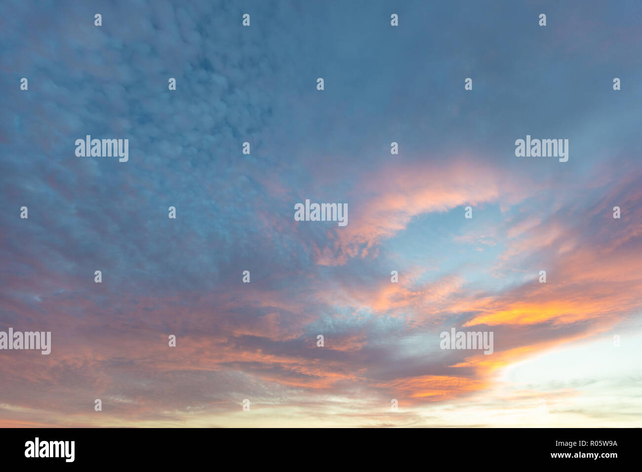 Dramatic colored sky. Moon and star in the clouds. Stock Photo