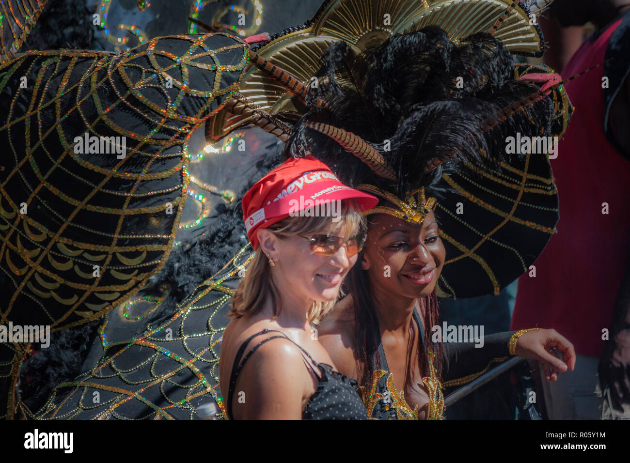 Black female participant and white female in the Caribana parade in Toronto - Canada Stock Photo