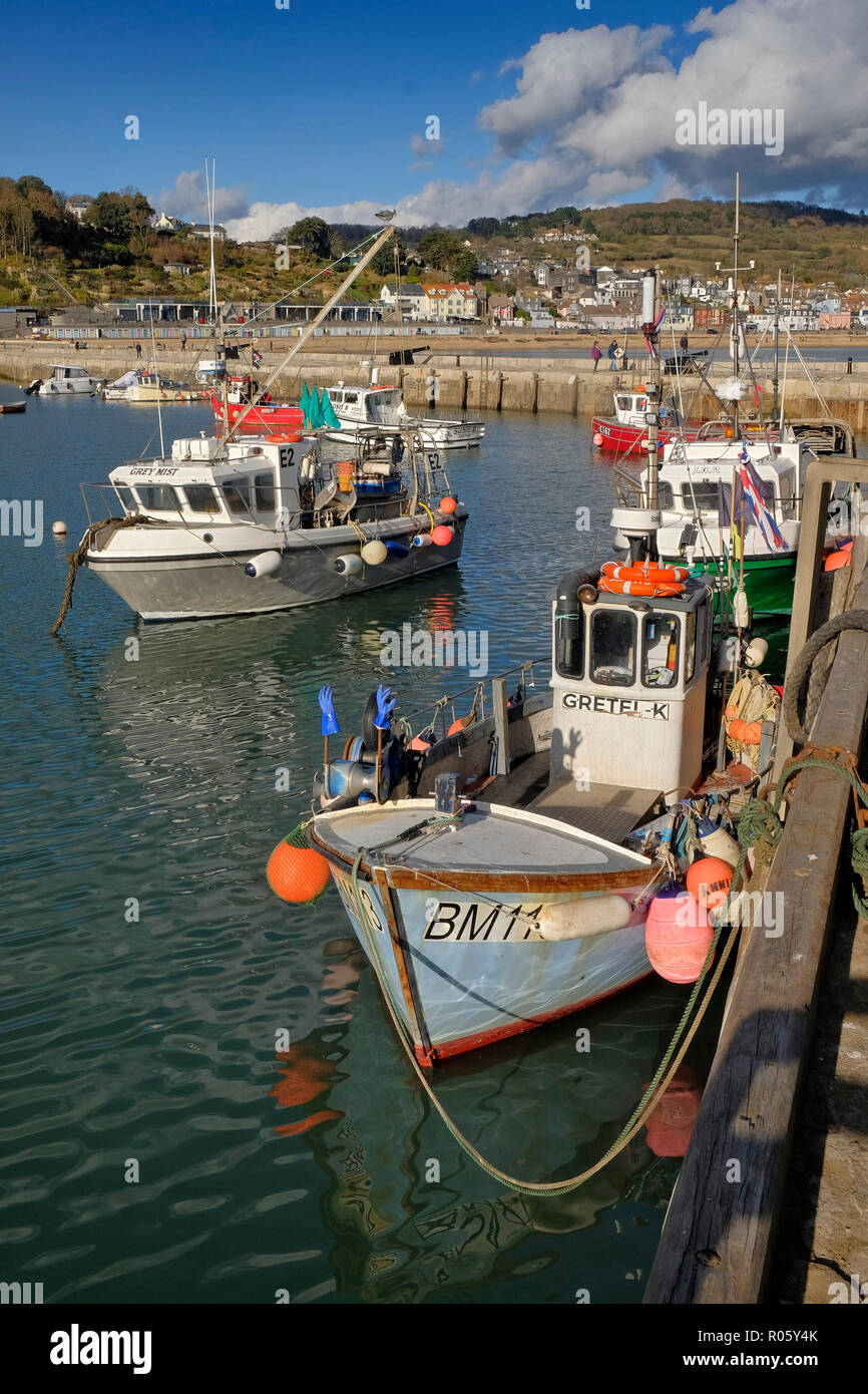 Lyme Regis, Dorset, UK, showing the town, harbour, The Cobb and fishing boats. Stock Photo