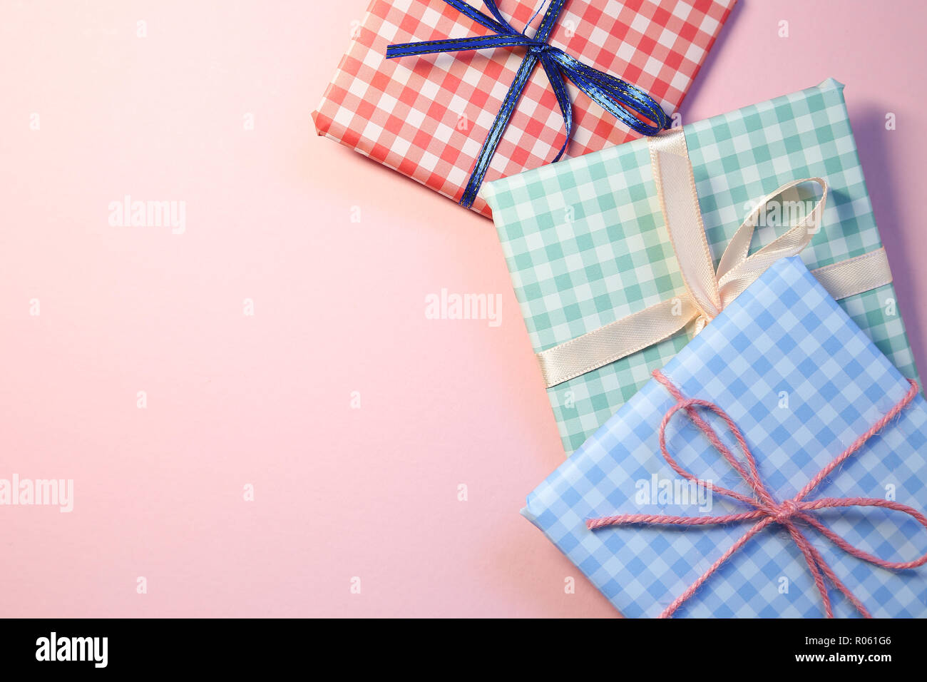 Check pattern colorful gift boxes on pink background Stock Photo