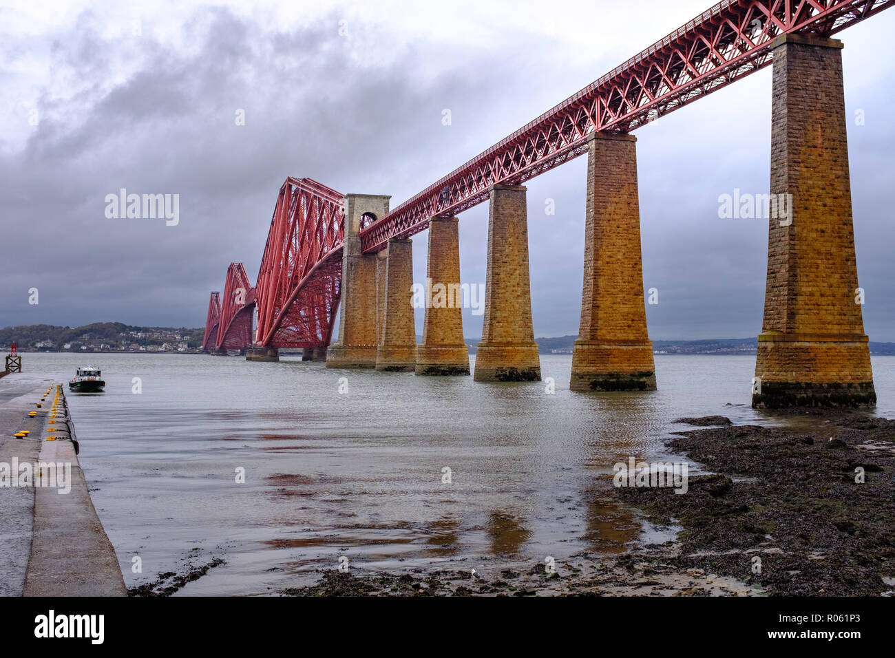 Horizontal View of Forth Bridge from viewed from South Queensferry on stormy day, Queens Ferry, Scotland, UK Stock Photo