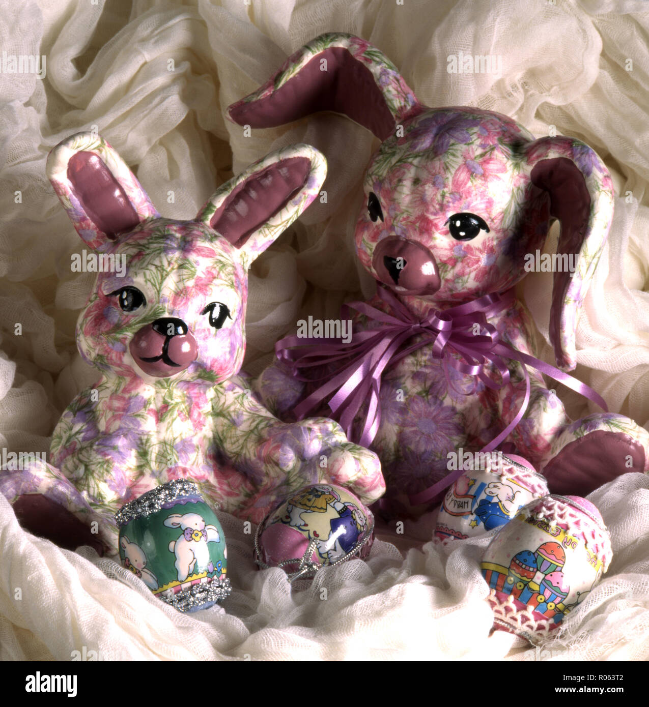 Colorful handmade Easter rabbits and decorated eggs. Stock Photo