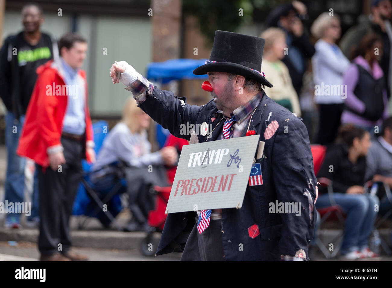 Portland, OR / USA - June 11 2016: Grand floral parade, old male person in a costume of clown bozo with 'trump for president' sign. Stock Photo