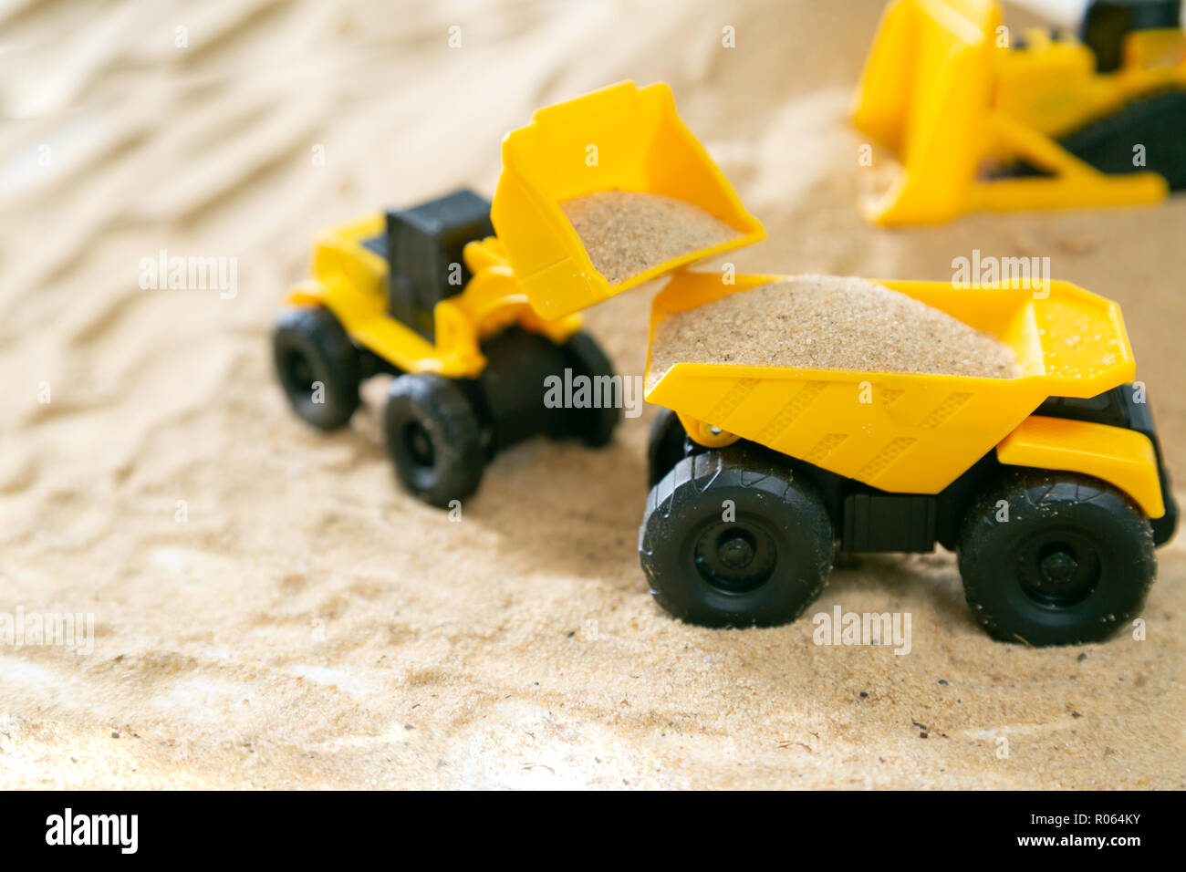 Construction concept - toy model machinery on sald, copy space Stock Photo