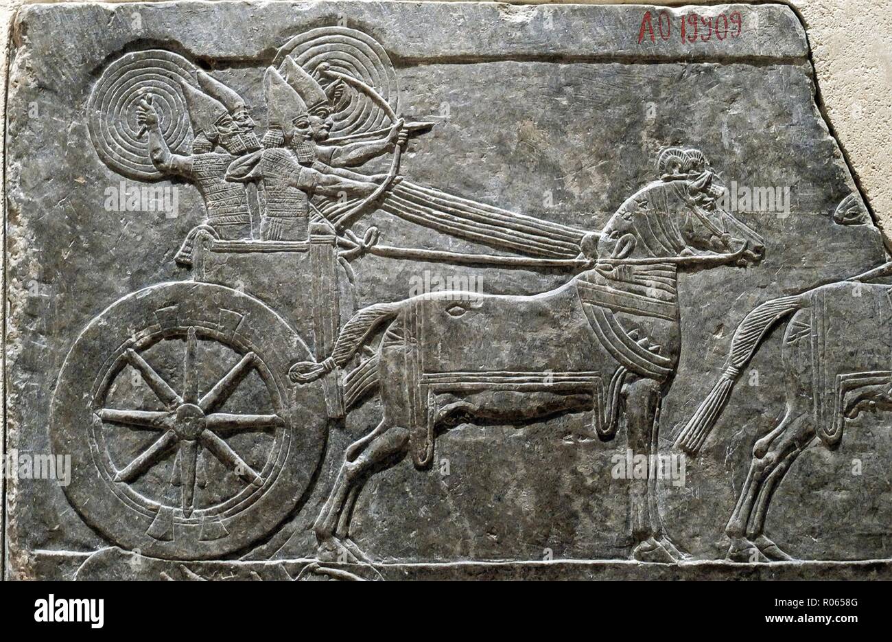 1379. ASSYRIAN WAR CHARRIOT IN BATTLE, RELIEF FROM SANAHERIB'S PALACE IN NINVEH, C. 700 B.C. 'The snorting of his horses was heard from Dan, the whole land trembled at the sound of the neighing of his stron ones, for they are come and have devoured the land and all that is in it...' JEREMIAH 8:16 Stock Photo