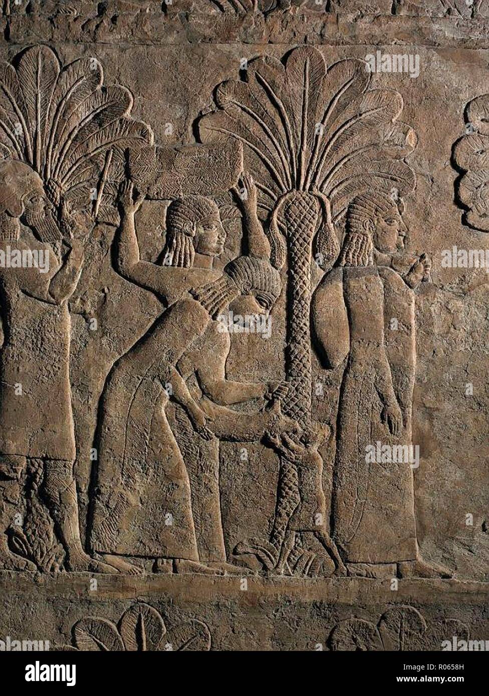 3663. WOMEN AND CHILDREN BEING DRIVEN AWAY FROM A CITY CAPTURED BY THE ASSYRIANS.  PIC: A WOMAN (POSSIBLY HIS MOTHER) GIVING WATER TO A CHILD FROM A WATER SKIN.  RELIEF FROM ASHURBANIPAL'S PALACE IN NINVEH, C. 7TH. C. BC Stock Photo