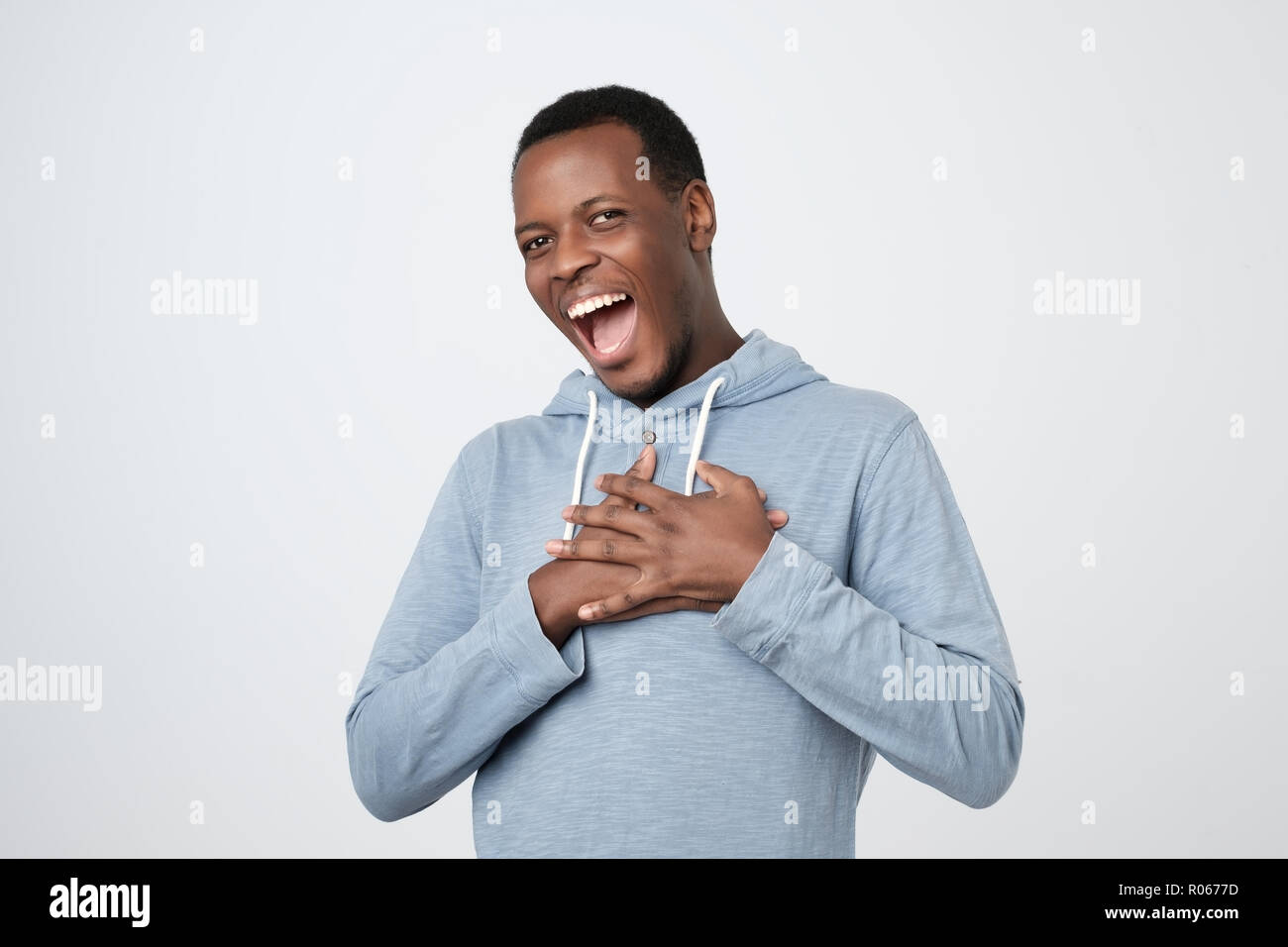 Excited african man smiling and looking at camera Stock Photo
