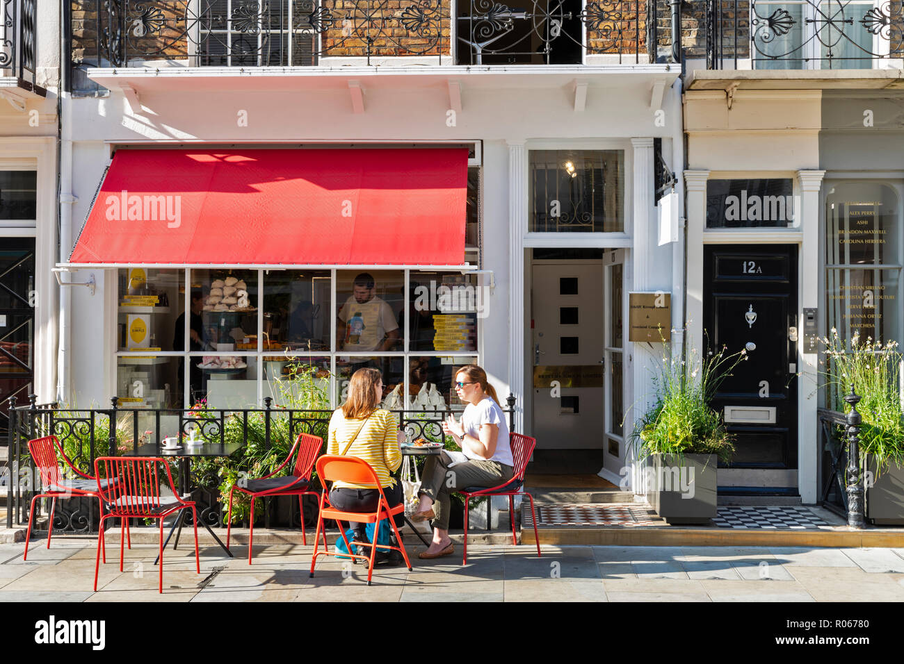 Young women enjoy lunch at Ottolenghi deli and cafe in Motcomb Street, Belgravia, Knightsbridge, London, England, UK Stock Photo