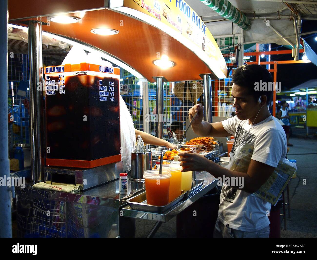 ANTIPOLO CITY, PHILIPPINES - OCTOBER 27, 2018: A customer puts sauce on