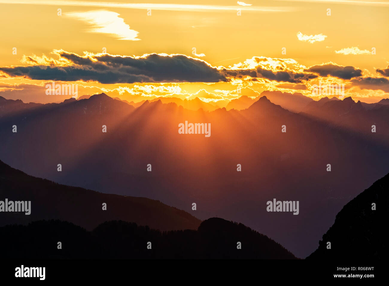 Sun rays at sunset on Pizzo Berro and Gerola Valley seen from San Marco Pass, Orobie Alps, Bergamo province, Lombardy, Italy, Europe Stock Photo