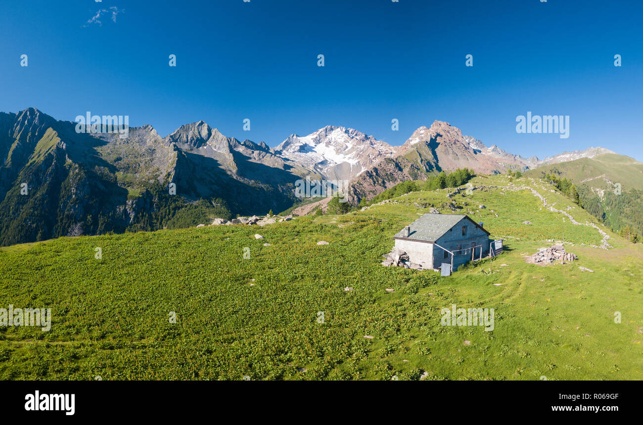 Panoramic aerial view of hut on green meadows, Scermendone Alp, Sondrio province, Valtellina, Rhaetian Alps, Lombardy, Italy, Europe Stock Photo