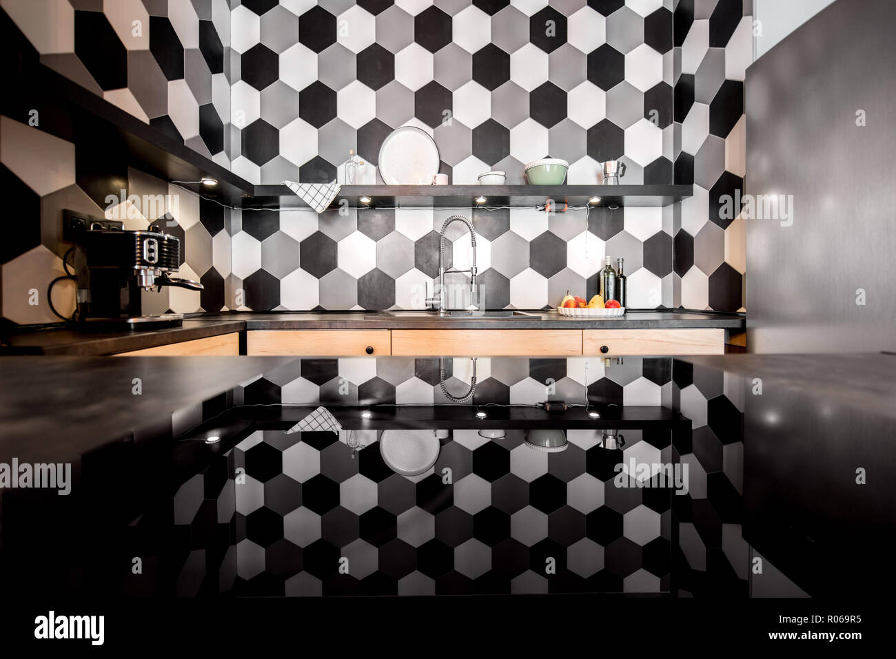 Loft kitchen interior with hexagonal black and white tiles Stock Photo ...