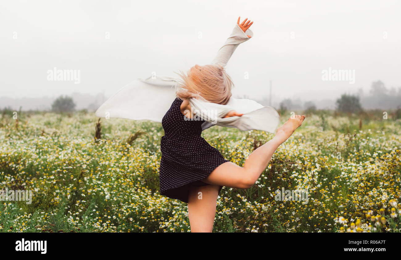 Portrait of young girl dancing in chamomile field in sunrise Stock ...