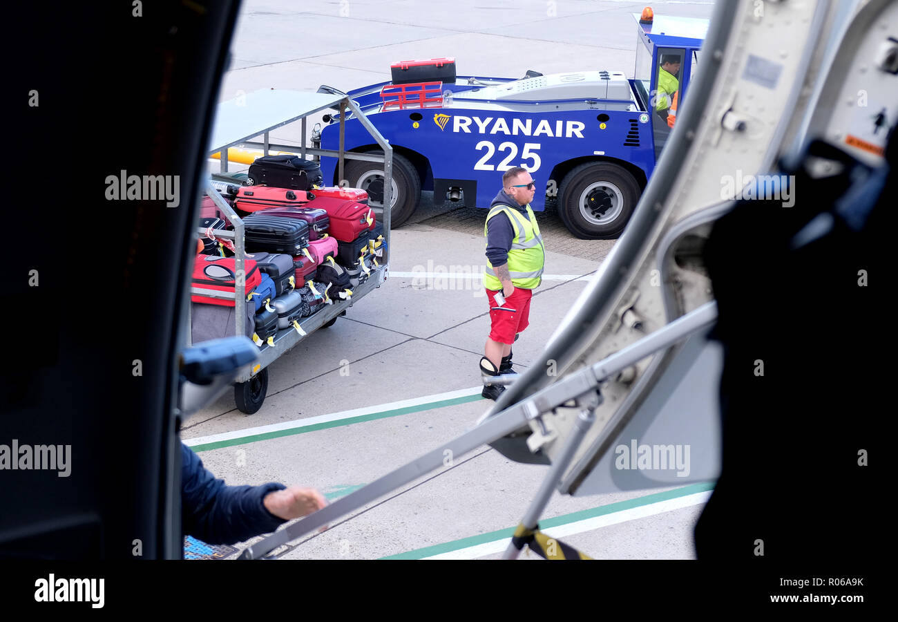 Pic shows: New tiny bag size allowed on Ryanair planes for free. Trolley  car full of bags that have been taken off passengers at the foot of the  airc Stock Photo -