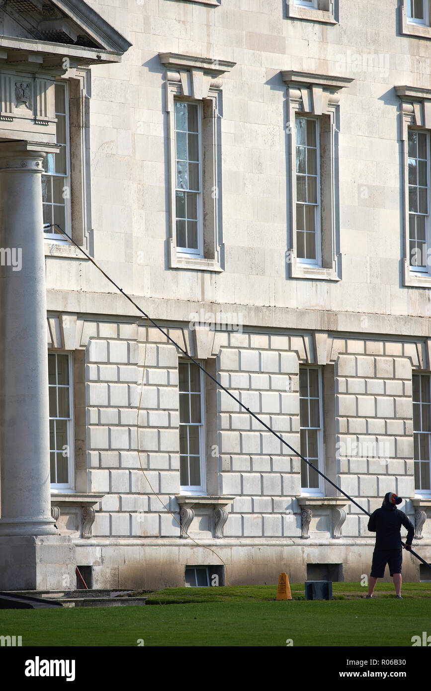 Window cleaner with long pole works on the windows of the Gibb's