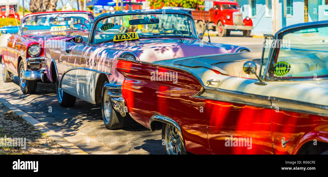 A row of classic American cars used as taxis in Varadero, Cuba, West Indies, Caribbean, Central America Stock Photo