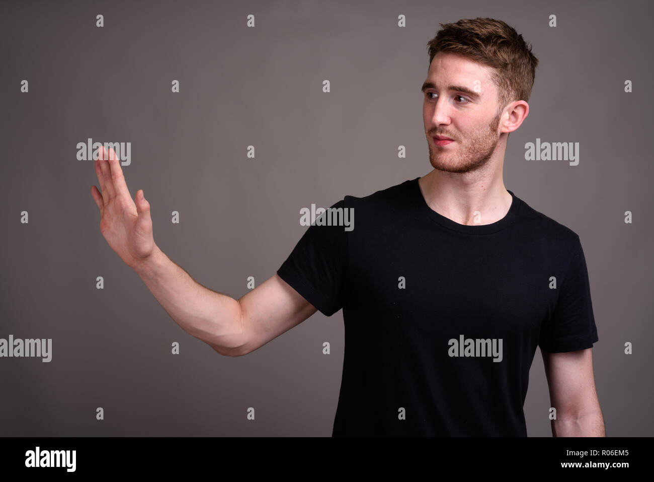 Young man showing palm of hand hi-res stock photography and images - Alamy