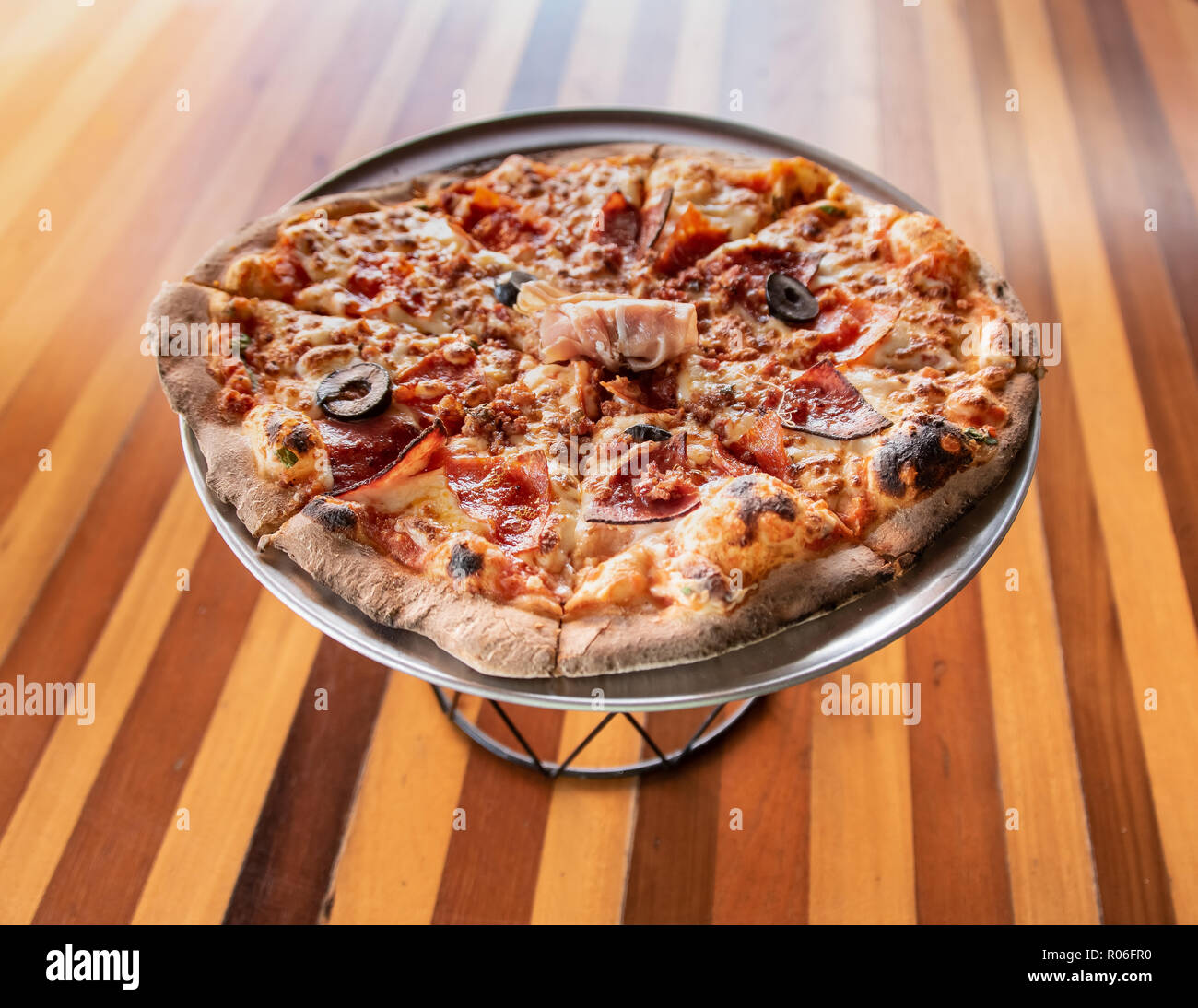 Handmade Italian Meat Pizza on pizza stand Stock Photo Alamy