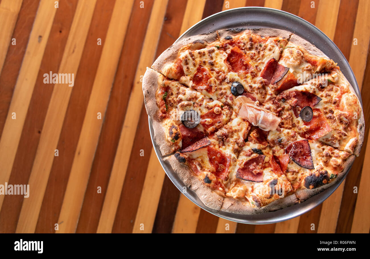 Handmade Italian Meat Pizza on pizza stand Stock Photo Alamy