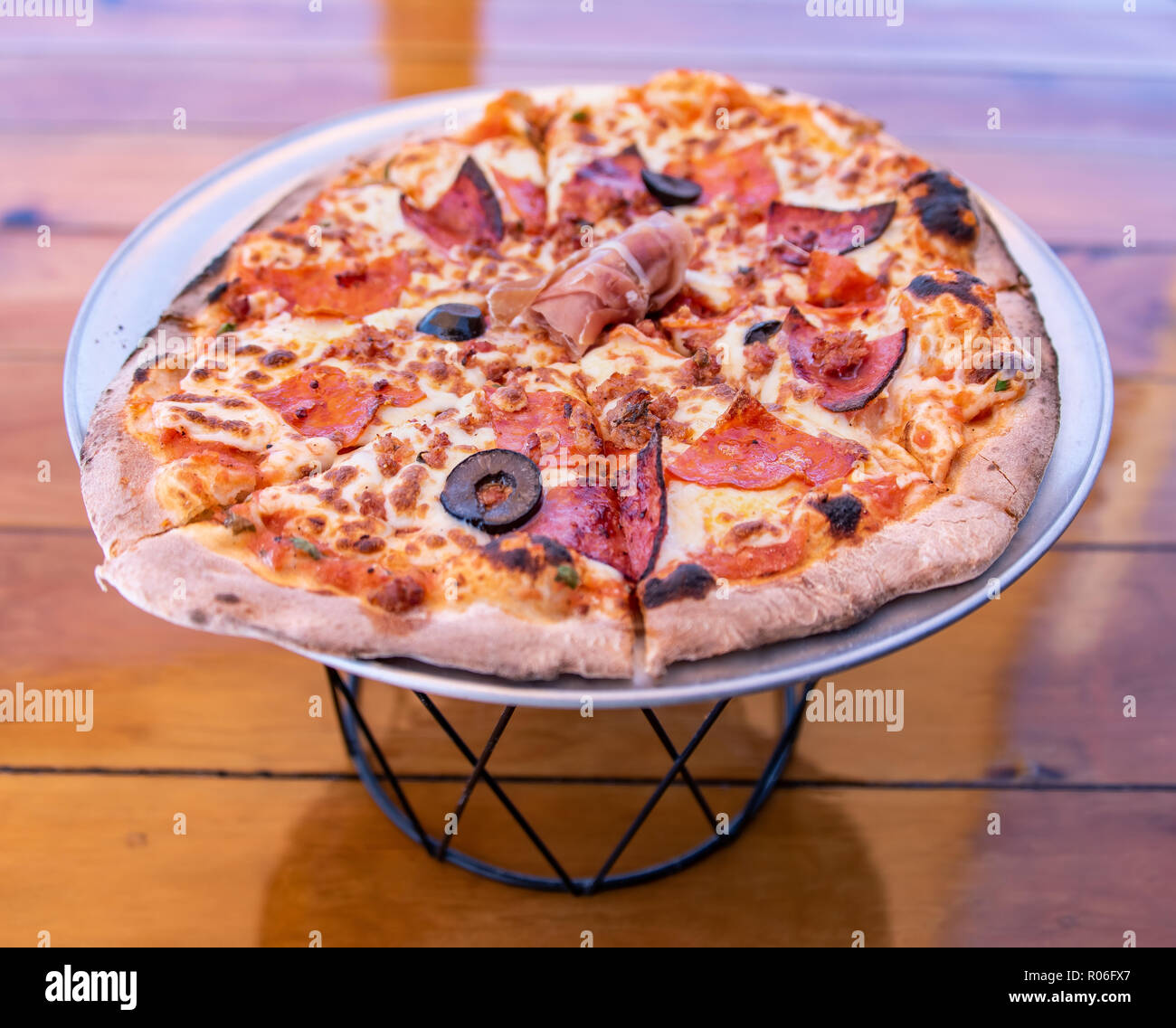 Handmade Italian Meat Pizza on pizza stand Stock Photo Alamy