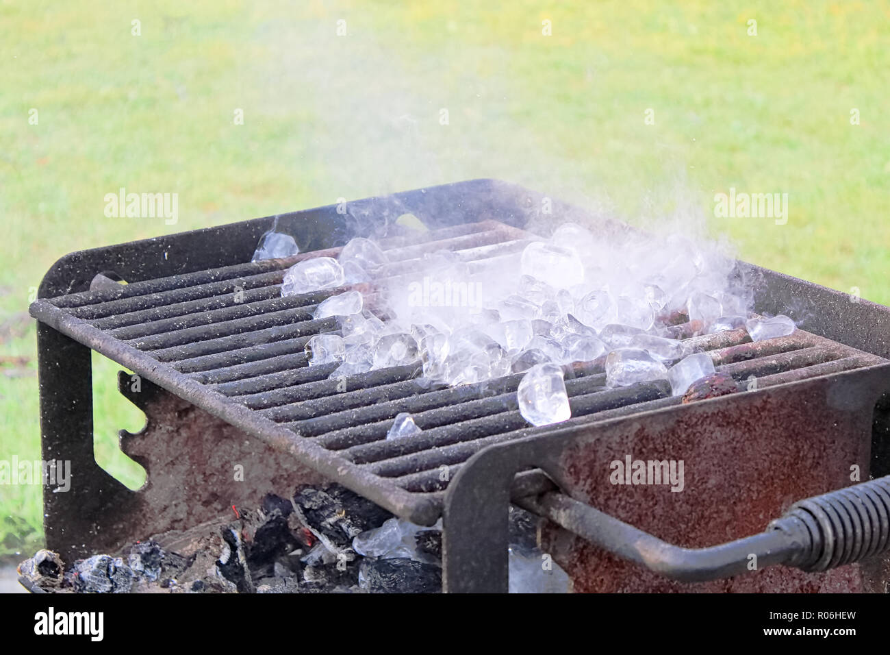 Ice melting on a hot BBQ grill Stock Photo