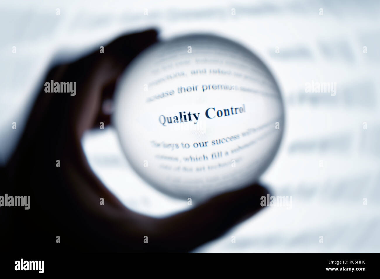 Crystal ball magnify computer screen word quality control Stock Photo