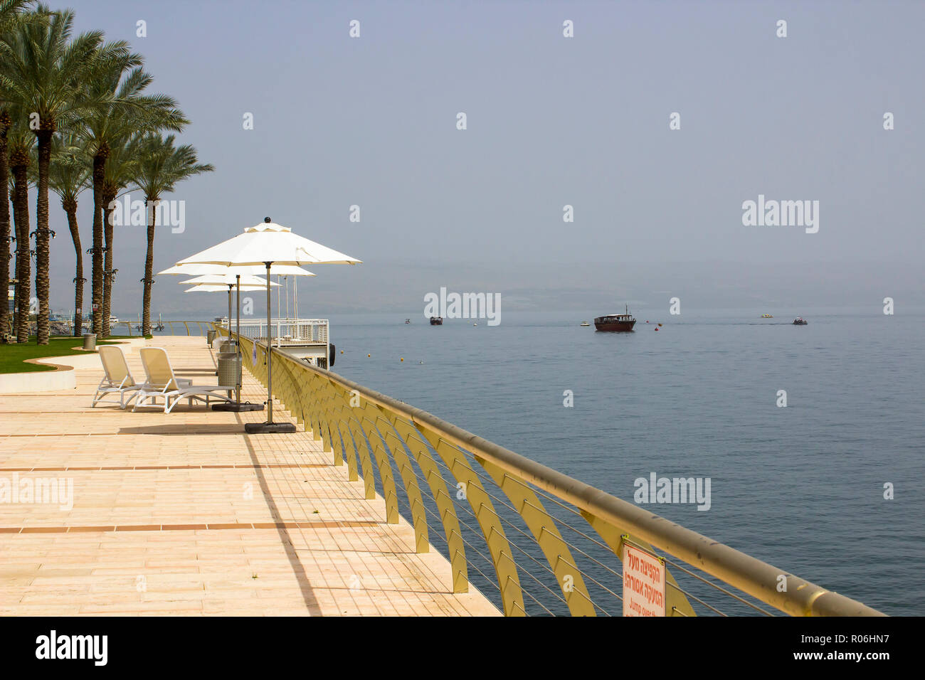 3 May 2018 A view northward along the coast line of the calm Sea of Galilee from Tiberias toward Capernaum through a soft early morning mist. Stock Photo