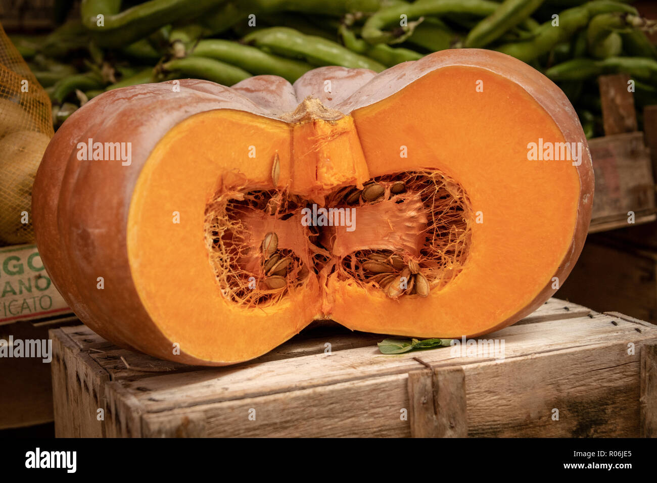 Pumpkin Sliced Open on a Wooden Box in Market Stock Photo
