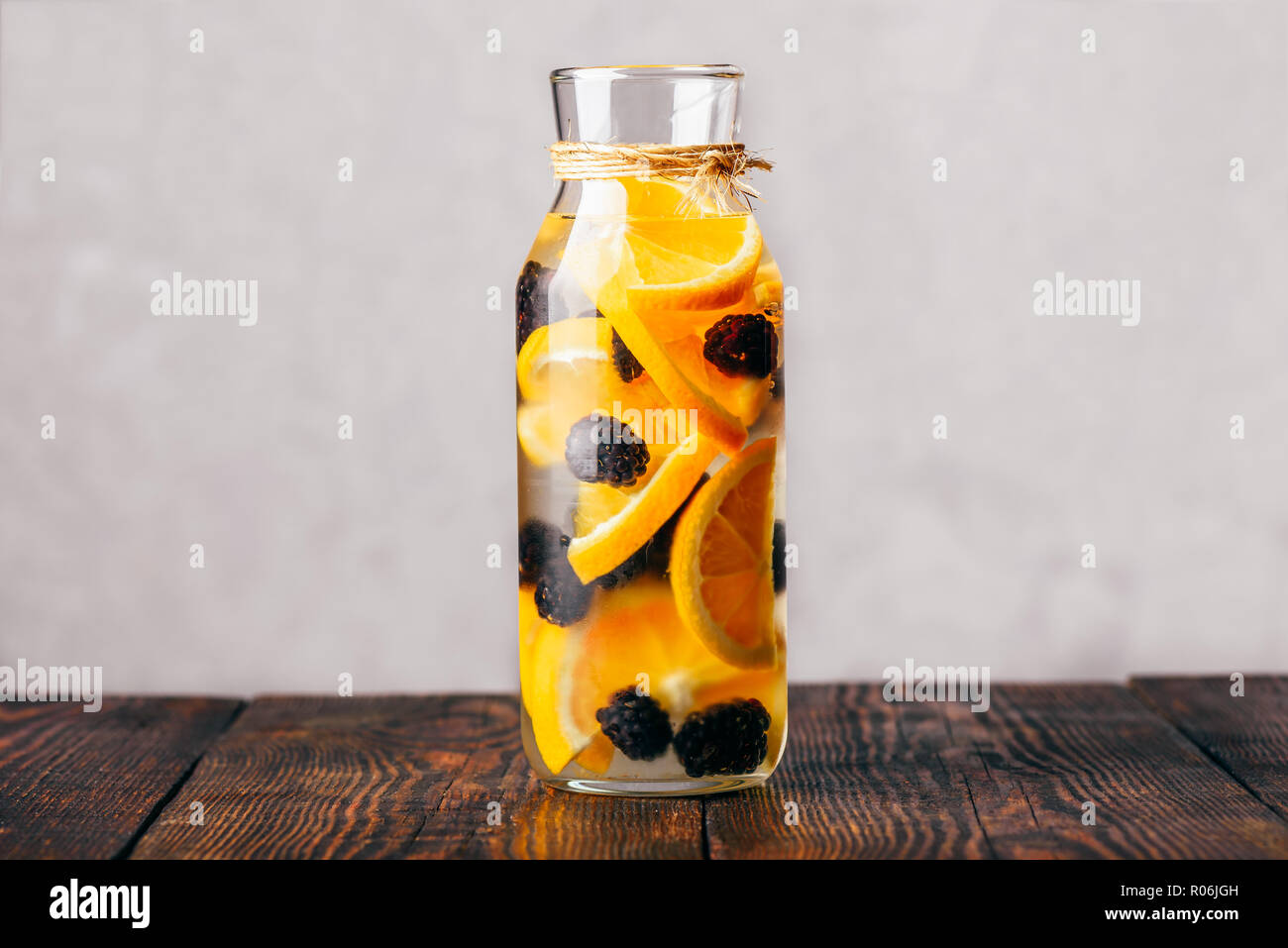 Bottle of Detox Water Infused with Sliced Raw Orange and Fresh Blackberry. Stock Photo