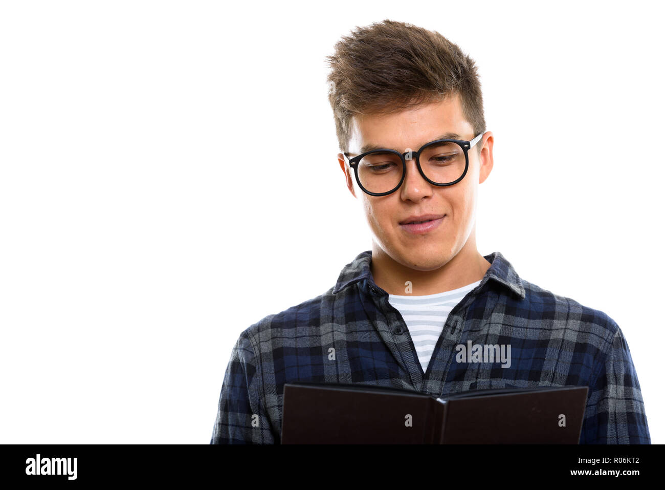 Close up of young handsome man reading book Stock Photo