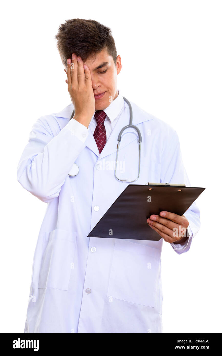Studio shot of young stressed man doctor holding clipboard  Stock Photo