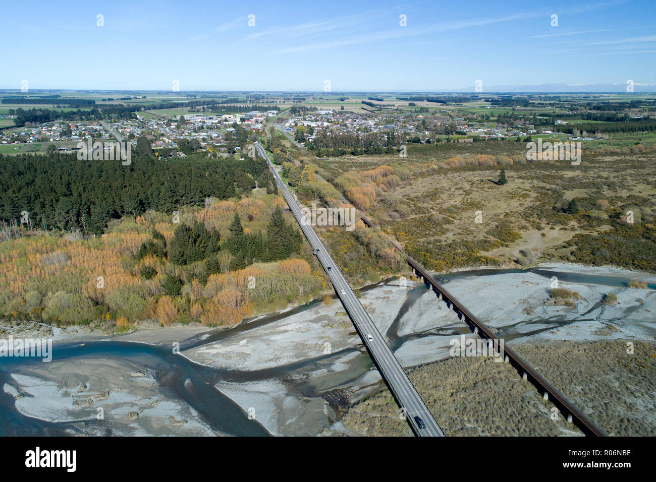 Road and rail bridges across Rakaia River, and Rakaia township, Mid Canterbury, South Island, New Zealand - aerial Stock Photo