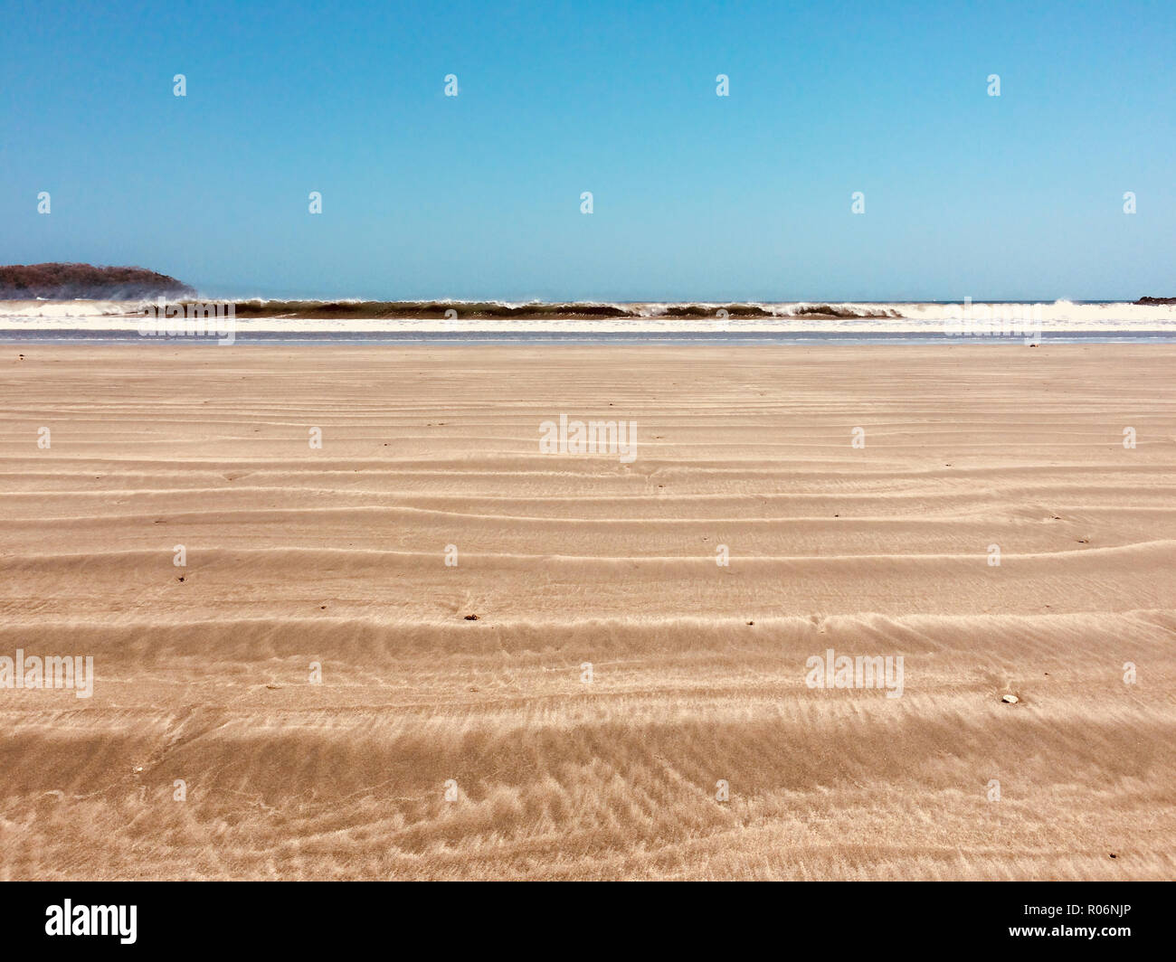 beach sand, ocean waves and blue sky background on sunny summer day ...