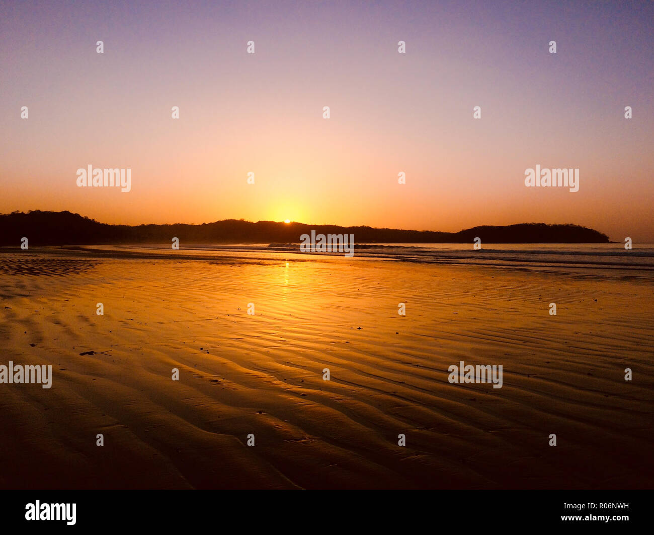 beautiful sunset sky at beach - evening sun over ocean Stock Photo