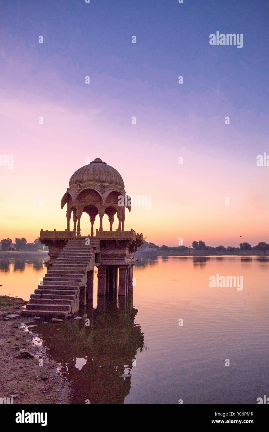 Stunning view of Gadi Sagar temple on Gadisar artificial lake at sunrise in Jaisalmer, India. Stock Photo