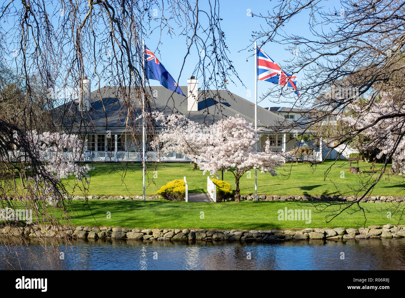 Flags flying on the grassy banks of the Avon River in Mona Vale, Christchurch Stock Photo