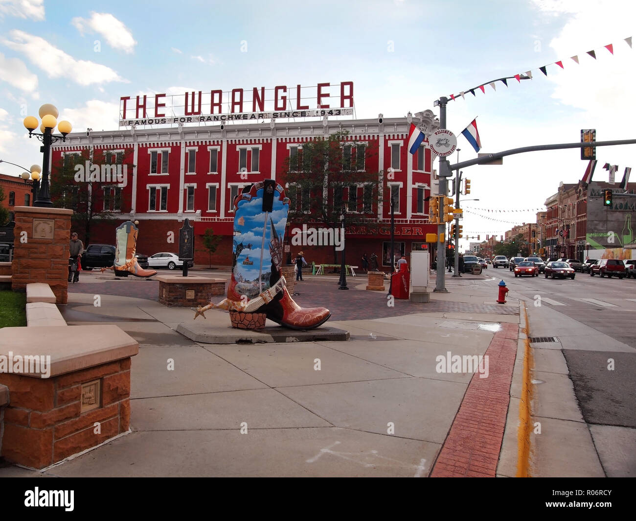 CHEYENNE, WY - JULY 25, 2018: The Wrangler western apparel shop and two of the 8 foot tall Cheyenne Big Boots, featuring local art work depicting Chey Stock Photo