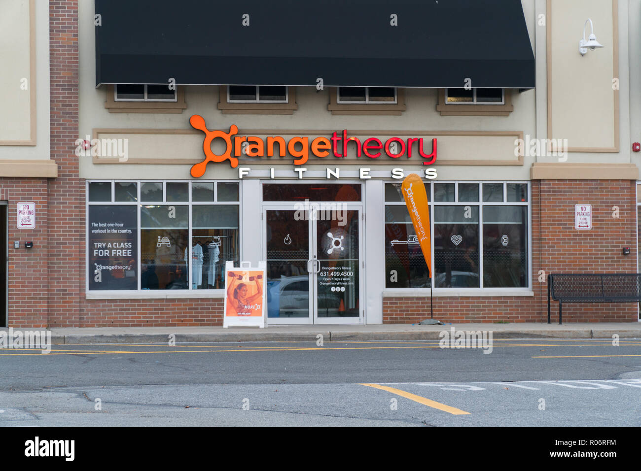 New York, USA - Circa 2018: Orange Theory Fitness exterior gym studio store  front franchise facade and sign. View from parking lot. Heart rate interva  Stock Photo - Alamy