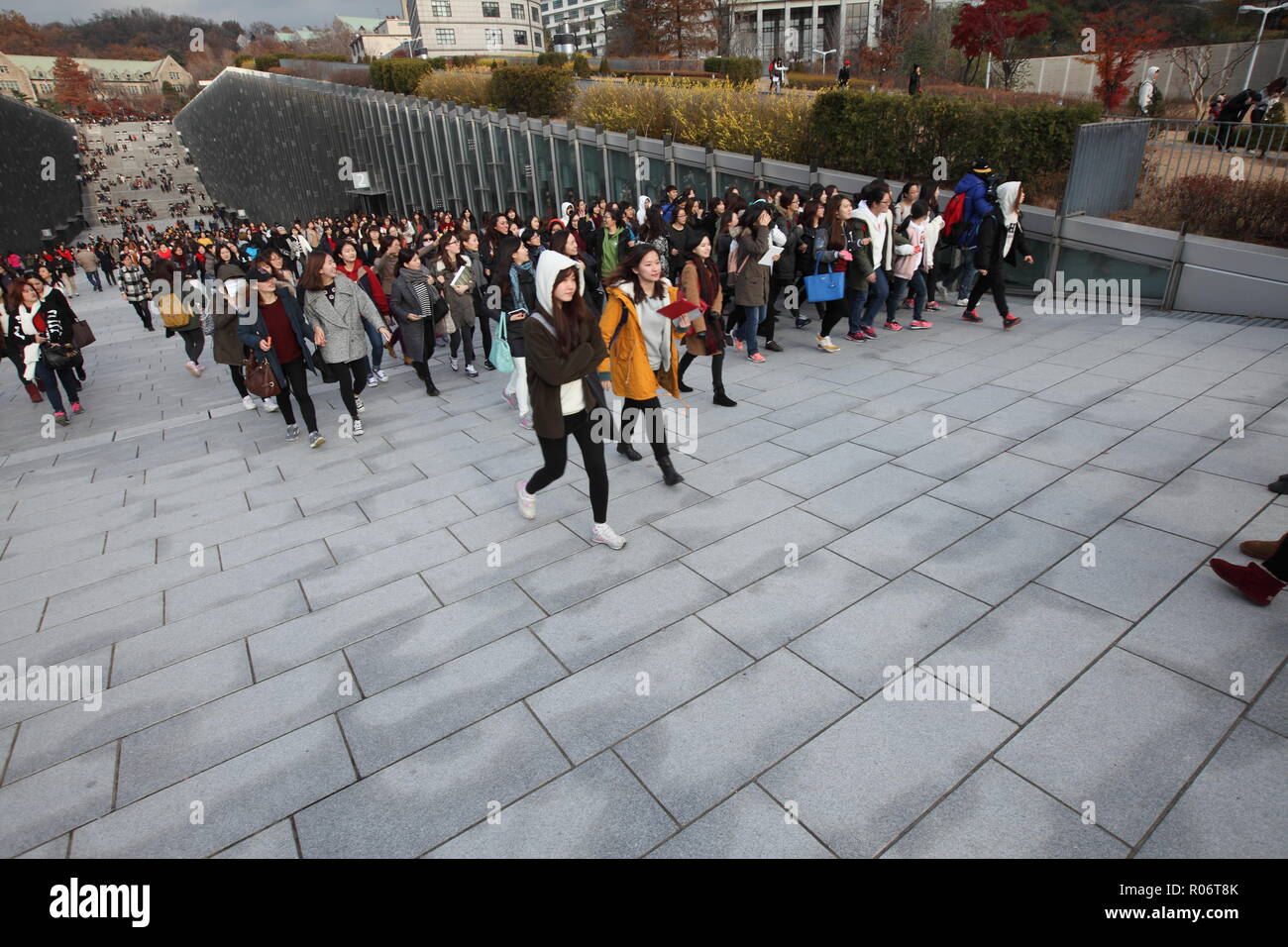 Hundreds of female students wearing winter jacket leaving Ewha Womans university premises after school, South Korea. Stock Photo