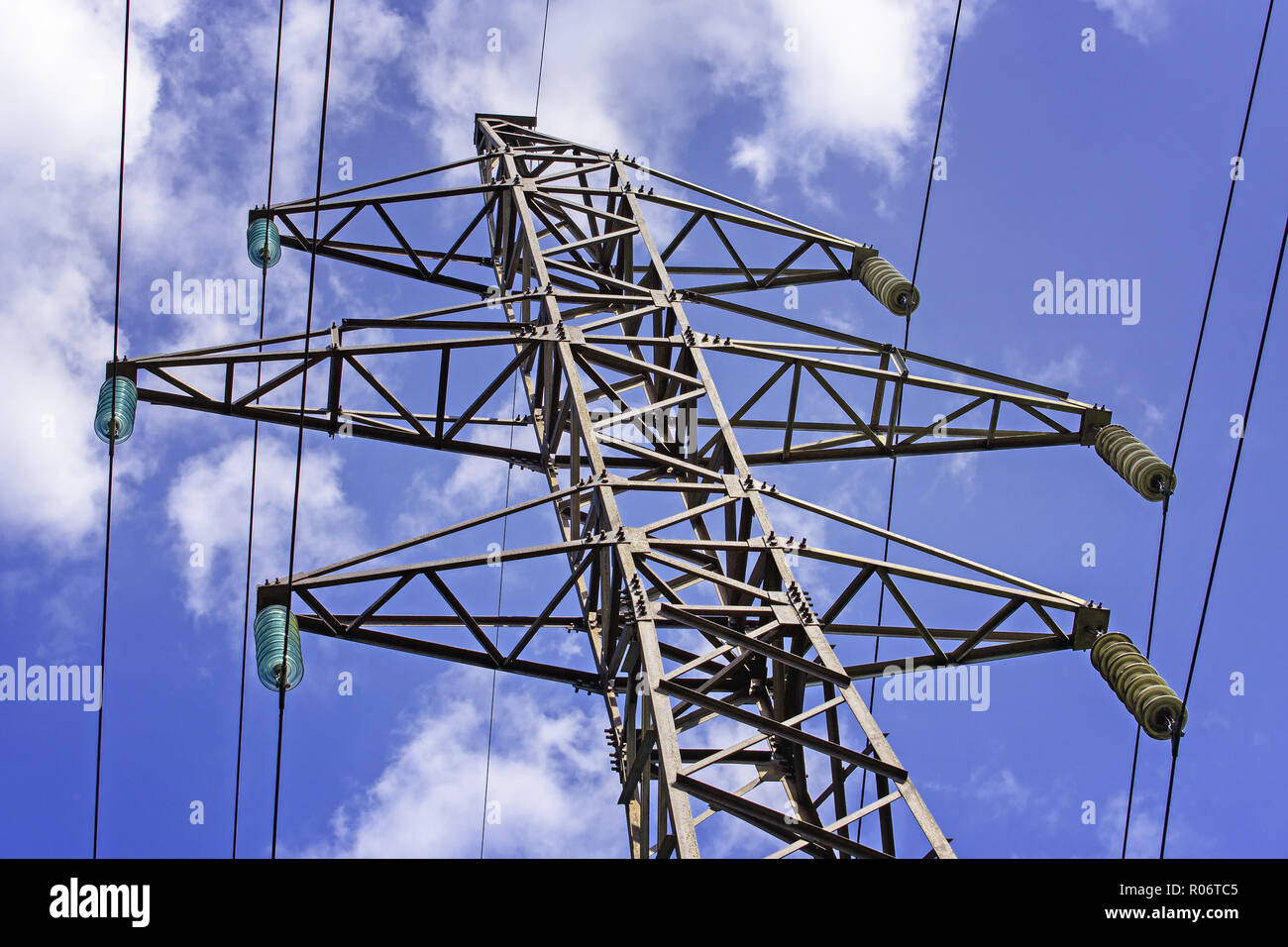 Industrial Scenery: Electric High Voltage Pylon on Blue Sky Background ...