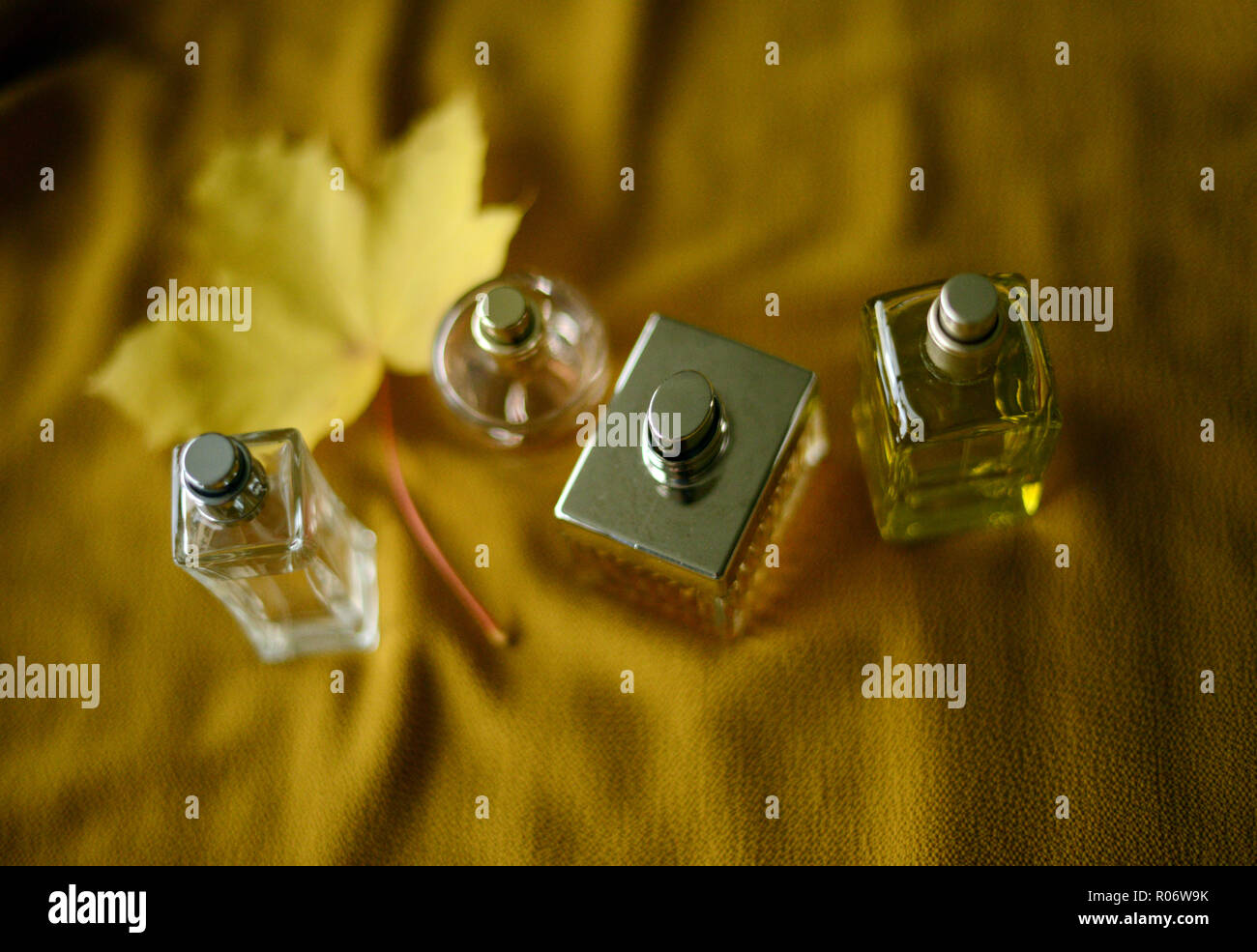 Download Four Perfume Bottles And One Yellow Leaf On A Yellow Background Stock Photo Alamy PSD Mockup Templates