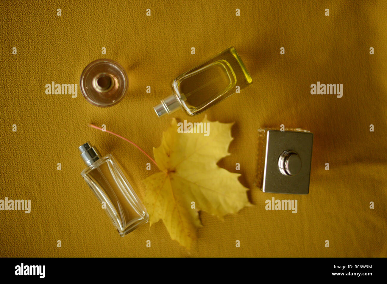 Download Four Perfume Bottles And One Yellow Leaf On A Yellow Background Stock Photo Alamy PSD Mockup Templates